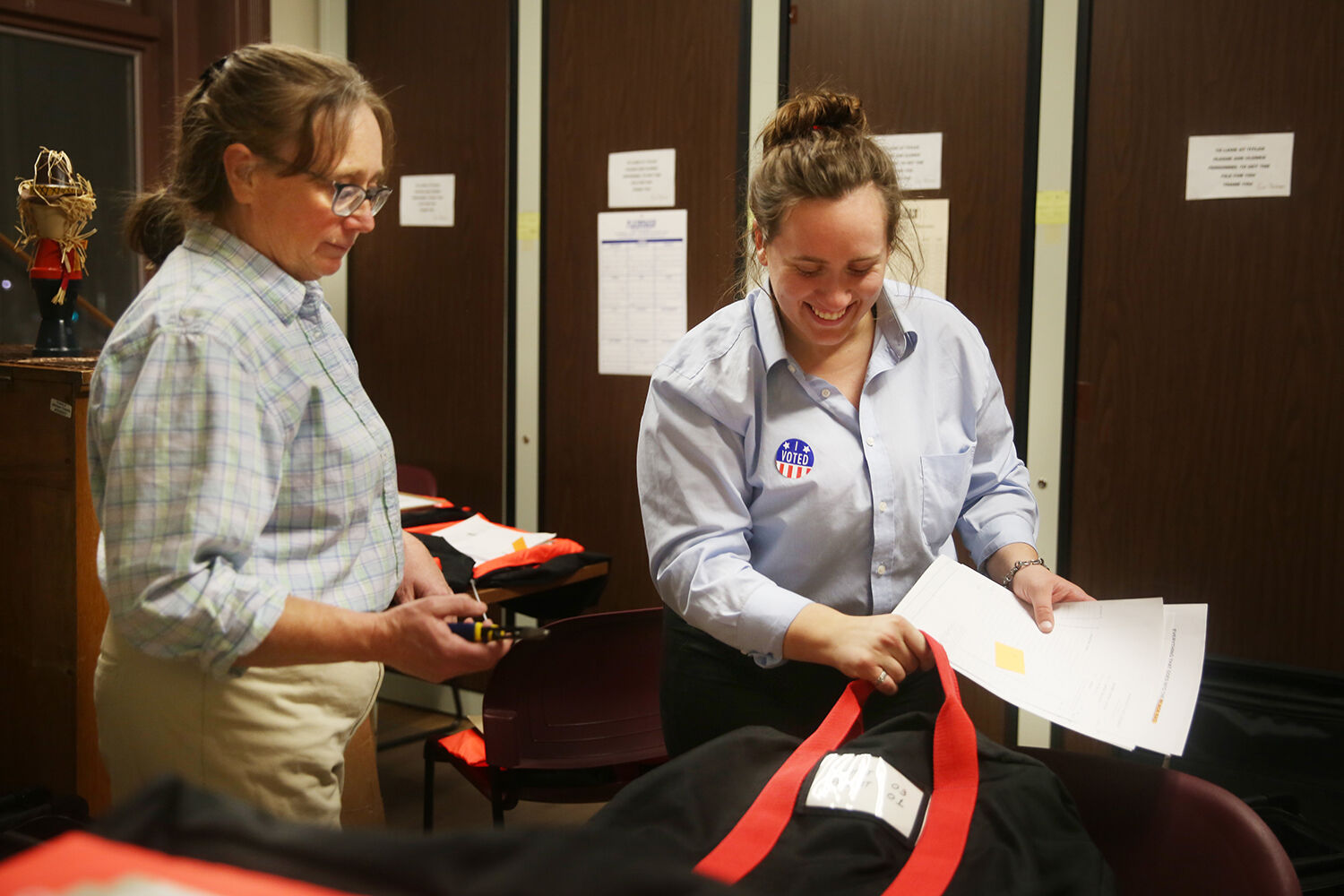 Taylor Klaahsen laughs as she unpacks a precinct pack in the courthouse